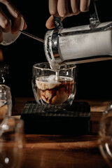 the effect of pouring cold milk into hot cup of coffee