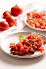 Italian starter bruschetta with fresh tomatoes, olive oil, garlic and basil