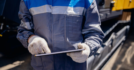 Closeup mobile tablet for control drilling rig for exploration of minerals for oil, gas and artisan...