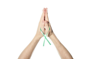 Green awareness ribbon in hand