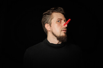 Bearded prankster with clothespin on nose. Funny joke concept.