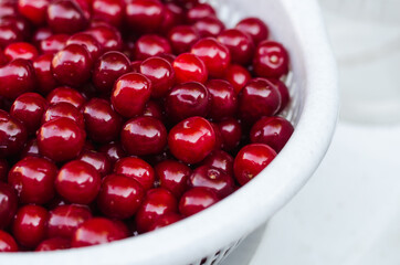 Beautiful red delicious cherries with white bowl