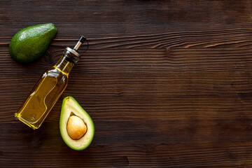 Bottle of avocado essence oil with raw avocado