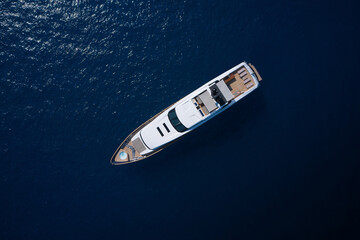 Super yacht on blue water top view. A huge white super Mega yacht on blue water in Italy. White...