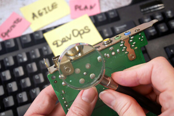 motherboard and sticker devops. DevOps Concept for software engineering culture and practice of...