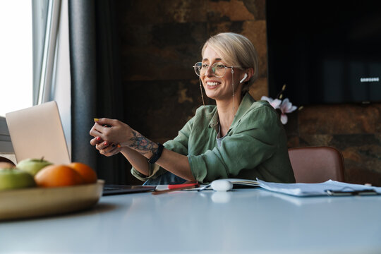 Middle Aged Blonde Woman With Short Hair Studying