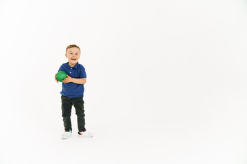 Boy with down syndrome holding toy and smiling at camera