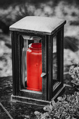 damaged grave light with  candle on a grave