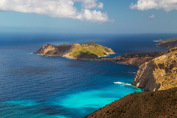 Aerial view at Asos village, Assos peninsula and fantastic turquoise and blue Ionian Sea water. Top view, summer scenery of famous and extremely popular travel destination in Cephalonia, Greece
