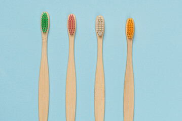 Bamboo toothbrush on a blue background. Top view.