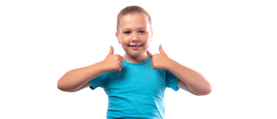 Happy little caucasian girl in a blue t-shirt shows thumbs up on a white background. Cheerful little blonde girl on white background