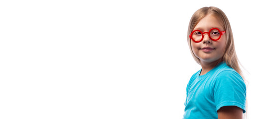 Cute little Caucasian girl in a blue T-shirt and round red glasses on a white background, place for text. Education concept