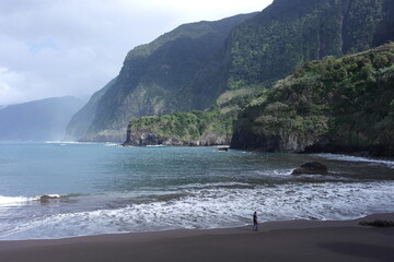 paradise inspiration: foam wave among volcanic beach,  on the shoreline of fresh breeze azure  Atlantic Ocean, Madeira Island, Portugal