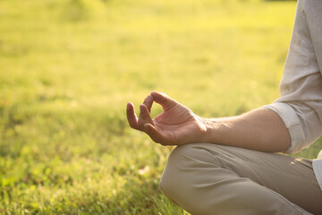 Man meditating outdoors on sunny day, closeup. Space for text