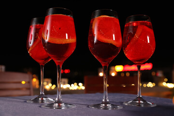 Glasses of cocktails on table in cafe with outdoor terrace