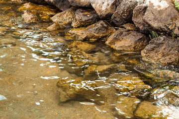 Stone coast and water close up