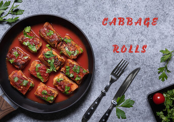 Ready to eat cabbage rolls with text on gray background