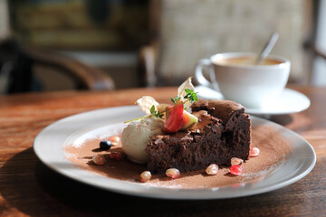 Chocolate cake with ice cream and coffee dessert on wood table