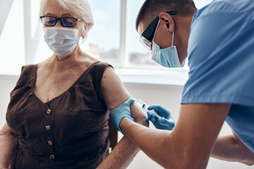 male doctor giving an injection immunization safety health care