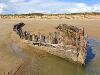 Shipwreck on the Cefn Sands beach at Pembrey Country Park in Carmarthenshire South Wales UK, which...