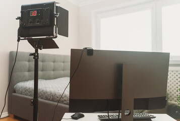 Webcam studio interior with lighting and camera.