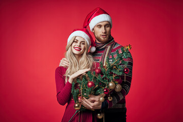 man and woman christmas tree toys fun holiday red background