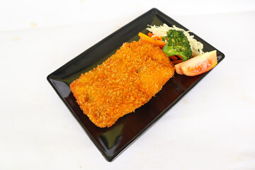 chicken katsu don is japanese food served with soy sauce on table
