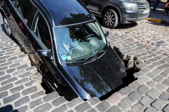 Riga/Latvia - June 5, 2020: Car fell into sinkhole which had opened after street surfacing caved in on Gertrudes Street during hydraulic tests