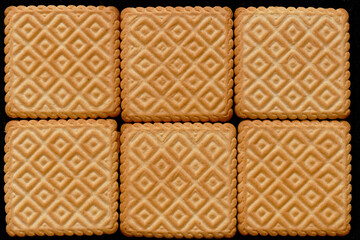 Six biscuits on black background