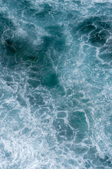 Aerial view of the ocean waves. Blue water background abstract texture
