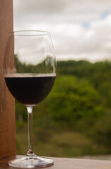 closeup to some crystal glasses with red wine alcoholic drink based on grape juice