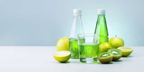 Green detox smoothie with kiwi and fruits on light mint color background with copy space. Banner.