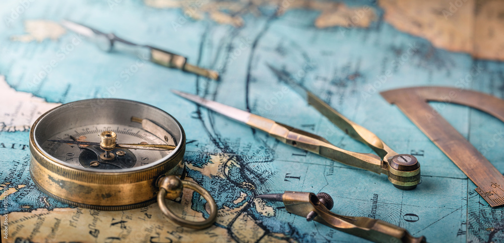 Poster an old geographic map with navigational tools: compass, divider, ruler, protractor. view of the work