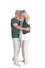 portrait of  senior couple taking selfie isolated
