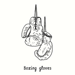 Boxing Gloves. Ink black and white doodle drawing in woodcut style.