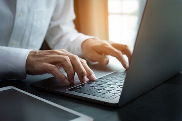 closeup hands of businessman working at office, Man typing keyboard on laptop or computer