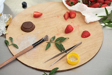 Pastry chef's palette board for final decoration of of pastries, cakes and desserts. Cake making...
