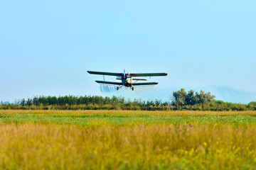 Fototapeta na wymiar Airplane of agricultural aviation which sprinkles the field from pests
