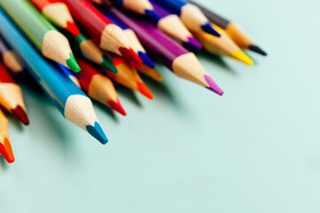 Sharp colored pencils for drawing lie on the table. Accessories for creativity and artists. background. Minimalism and aesthetics.