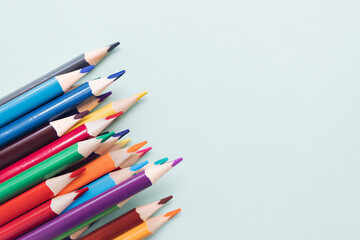 Background with colored pencils and space for copying. Top view. Creative background.