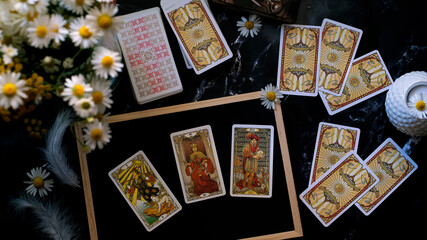 Fototapeta na wymiar Tarot cards on the table, esoteric concept, fortune telling and predictions