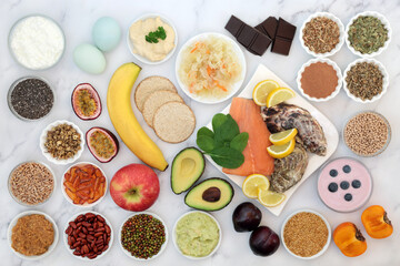 Bipolar disorder and manic depression mood stabilising health food high in omega 3, protein, selenium, magnesium, vitamins, serotonin, tryptophan. Variety of foods, natural herbal medicine concept.  