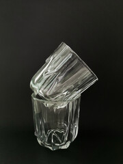 Two faceted glasses on a black background