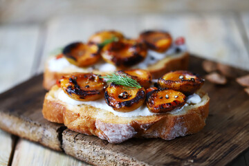 Sandwiches with dried apricots and white cheese. Healthy snack with apricot. Summer bruschetta with apricots.