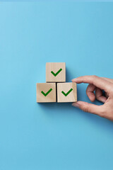 Wooden blocks with drawings of checkmarks. A symbol of consent and correct choice