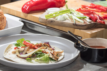 Chicken fajita. Tortilla wraps preparation with onions peppers and salsa