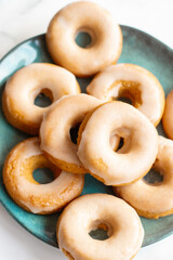Home made baked whole wheat vegan donuts with orange glaze