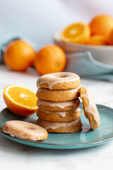 Home made baked whole wheat vegan donuts with orange glaze