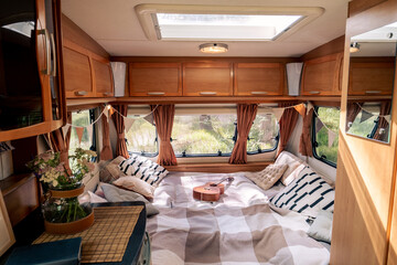 Large bed with pillows and guitar in the center of modern house on wheels