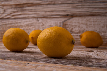 Freshly cut half and whole lemons on rustic boards.